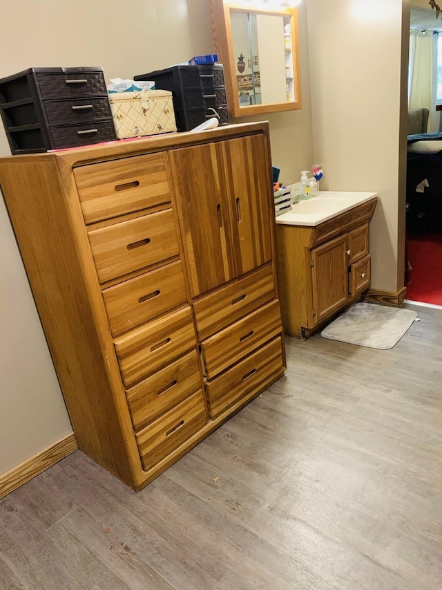 bathroom with hardwood / wood-style flooring and vanity