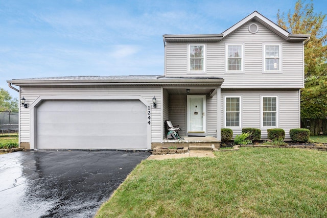 front of property featuring a garage and a front lawn