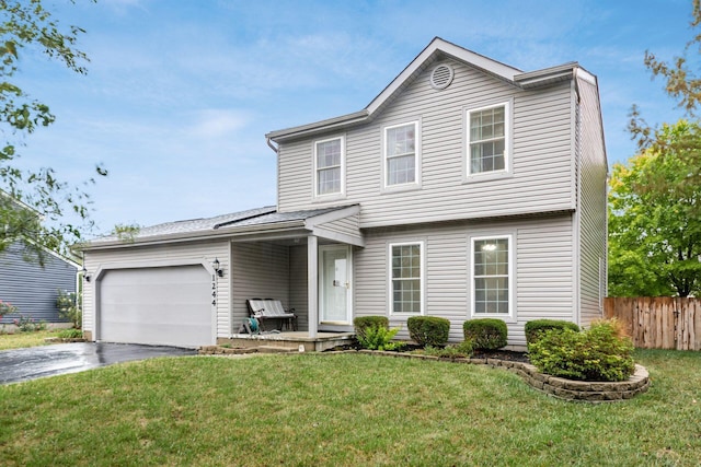 front facade featuring a front yard and a garage