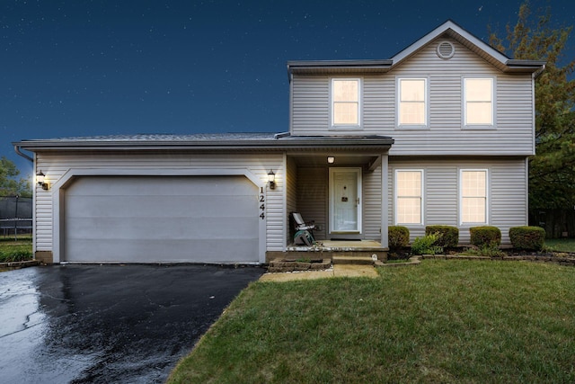 front facade with a front lawn and a garage