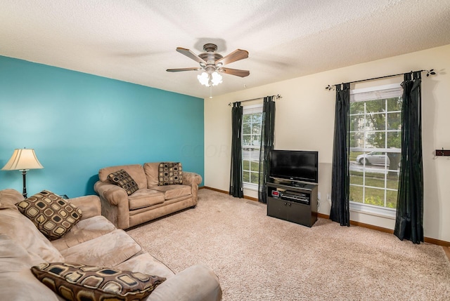 carpeted living room featuring a textured ceiling, a wealth of natural light, and ceiling fan