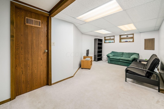 carpeted living room with a drop ceiling