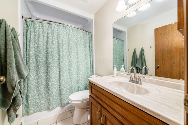 bathroom with tile patterned flooring, vanity, and toilet