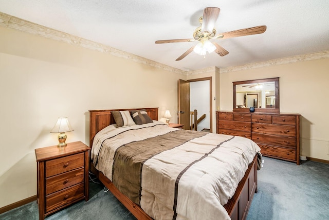 bedroom with ceiling fan, a textured ceiling, and dark colored carpet