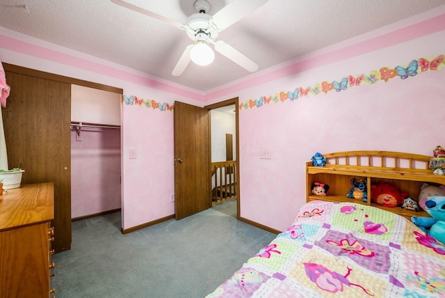 bedroom with ceiling fan, a closet, light colored carpet, and a textured ceiling