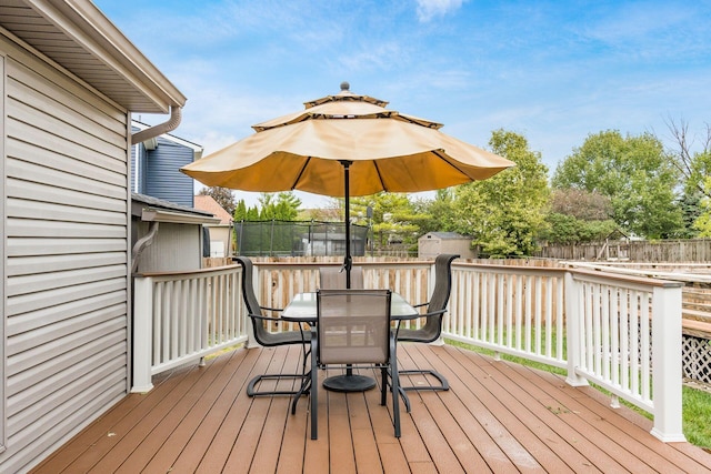 wooden terrace with a trampoline