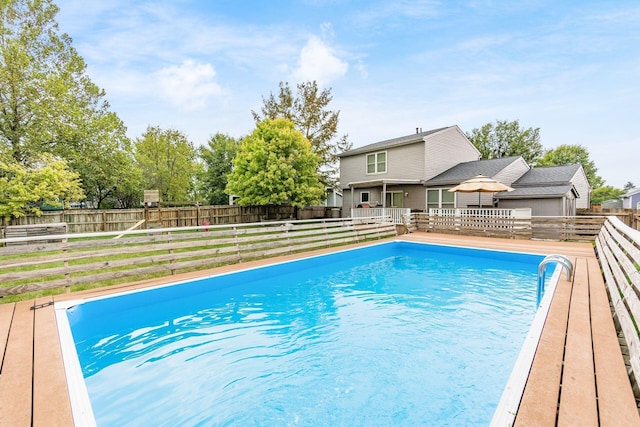 view of swimming pool with a wooden deck