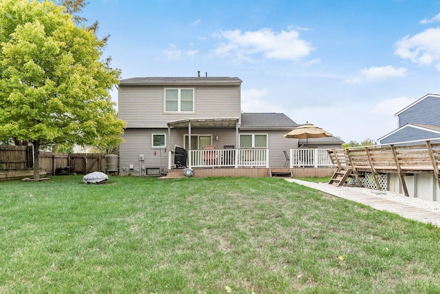 back of property featuring a pergola, a yard, and a wooden deck