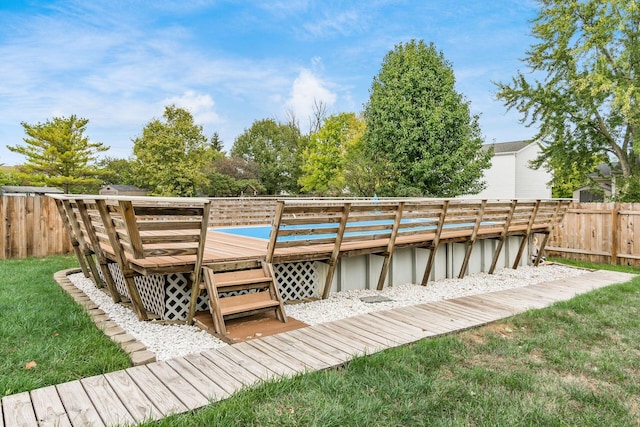 deck with a yard and a covered pool