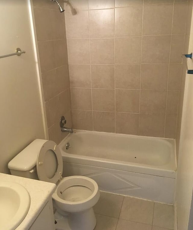 full bathroom with toilet, vanity, tile patterned floors, and tiled shower / bath