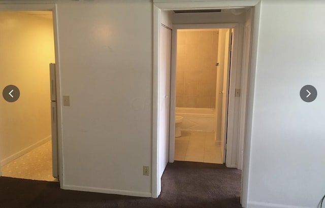 corridor featuring dark tile patterned floors