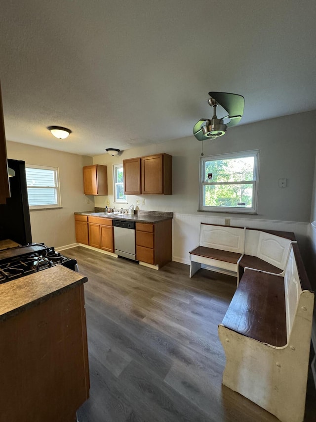 kitchen with dishwasher, a textured ceiling, black refrigerator, and dark wood-type flooring