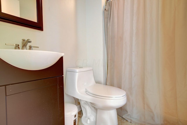 bathroom with tile patterned flooring, vanity, and toilet