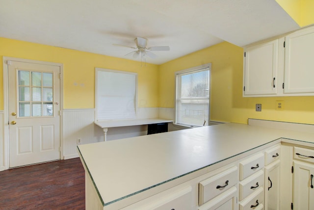 kitchen with ceiling fan, white cabinetry, dark hardwood / wood-style flooring, and kitchen peninsula