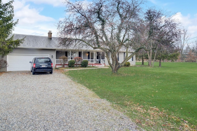 single story home featuring a front lawn, covered porch, and a garage