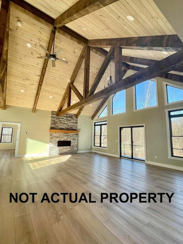 unfurnished living room with a stone fireplace, high vaulted ceiling, and wood-type flooring