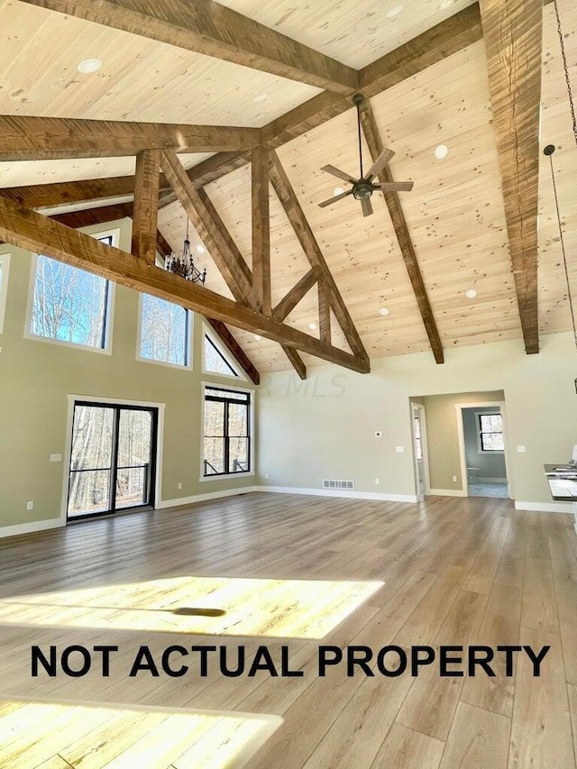 unfurnished living room featuring beamed ceiling, hardwood / wood-style floors, and high vaulted ceiling