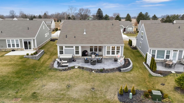 rear view of house featuring an outdoor hangout area, a patio area, a yard, and a hot tub