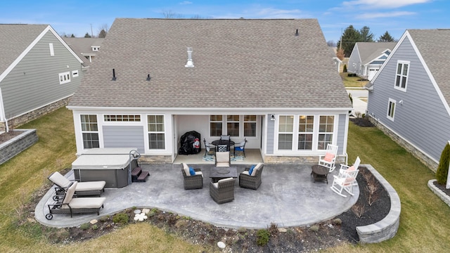 back of property featuring a lawn, an outdoor living space, a patio, and a hot tub