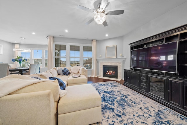 living room featuring ceiling fan and hardwood / wood-style floors