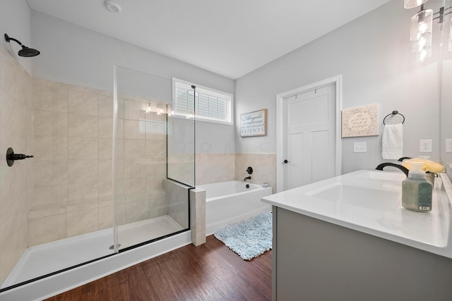 bathroom featuring hardwood / wood-style floors, vanity, and shower with separate bathtub