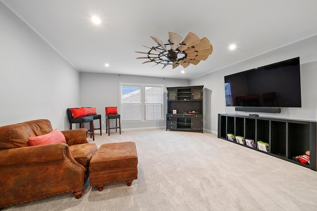 living room featuring carpet flooring, ceiling fan, and crown molding