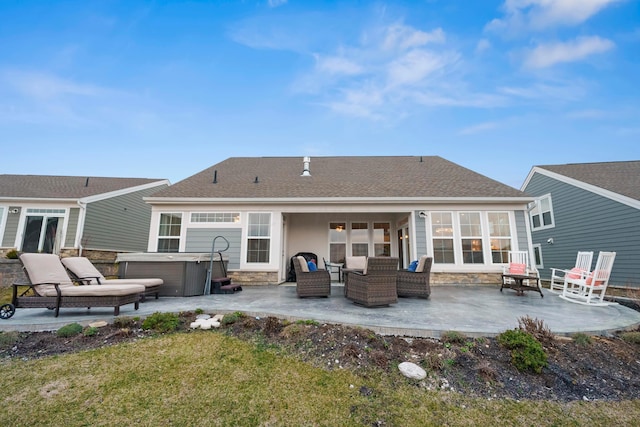 back of house with a patio area, an outdoor hangout area, a yard, and a hot tub