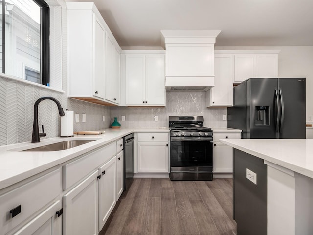 kitchen with white cabinetry, sink, stainless steel appliances, tasteful backsplash, and dark hardwood / wood-style flooring