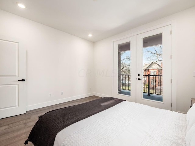 bedroom featuring access to exterior, hardwood / wood-style floors, and french doors