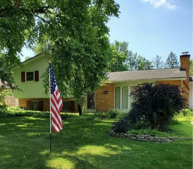 3081 Minerva Lake Rd, Columbus, OH 43231 - rear view of house featuring brick siding, a chimney, and a yard