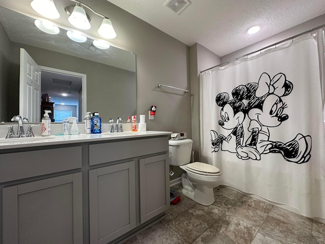 full bathroom with vanity, a textured ceiling, toilet, and shower / tub combo with curtain