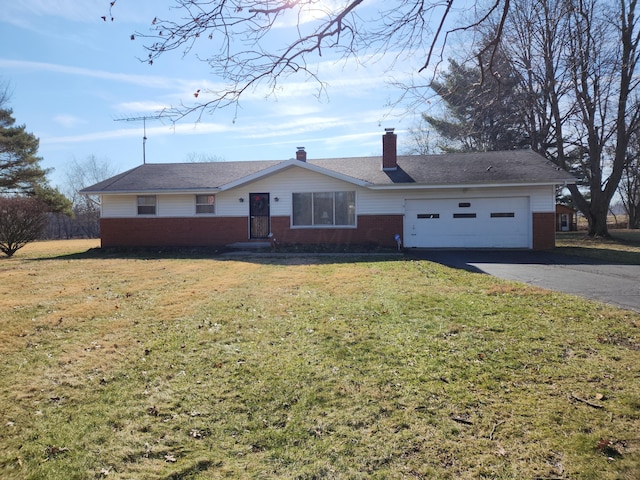 ranch-style house with a garage and a front lawn