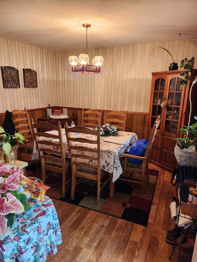 dining area featuring dark hardwood / wood-style flooring and a chandelier