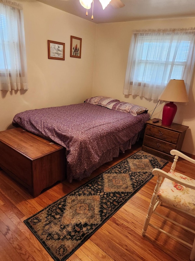 bedroom with ceiling fan and hardwood / wood-style floors