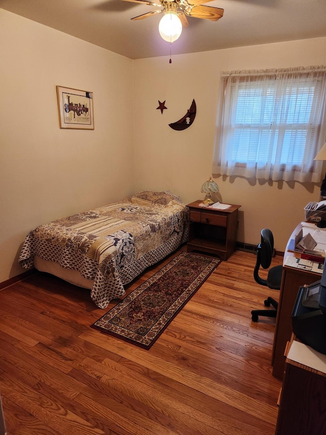 bedroom featuring hardwood / wood-style floors and ceiling fan