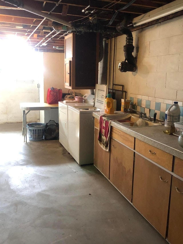 basement with separate washer and dryer and sink