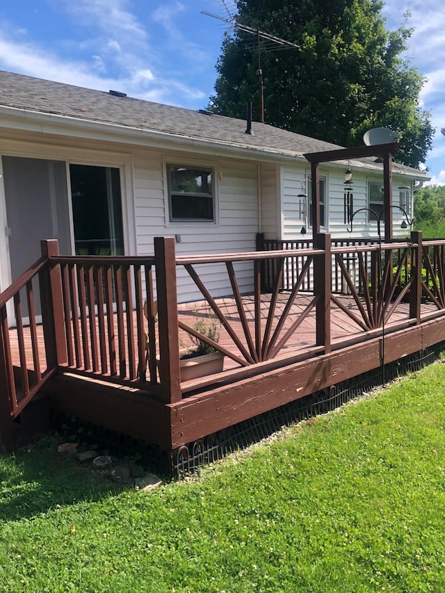 wooden deck with a lawn