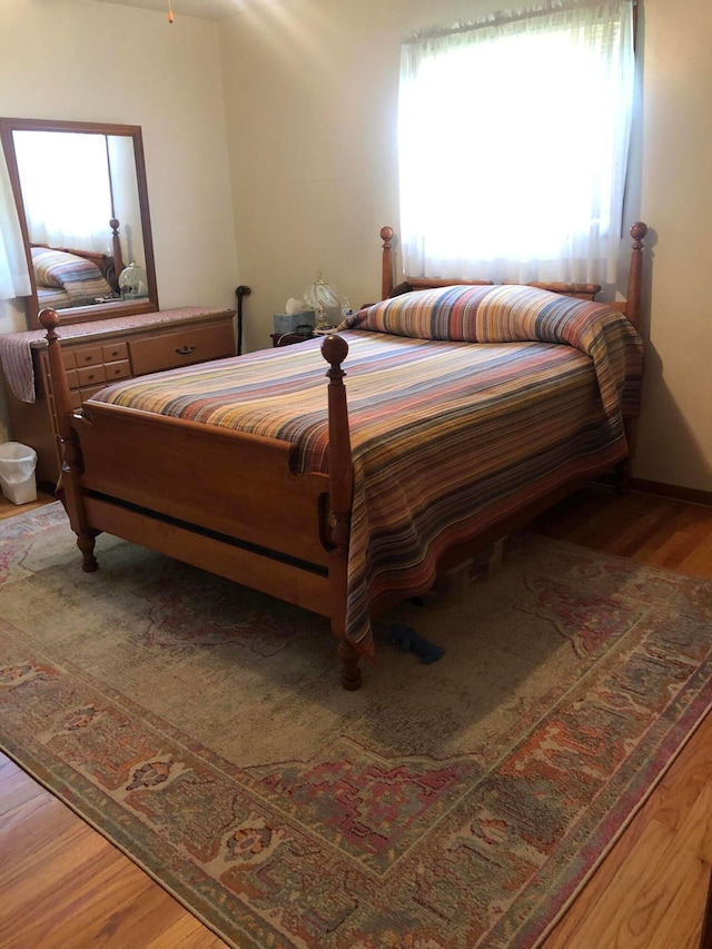 bedroom with hardwood / wood-style floors