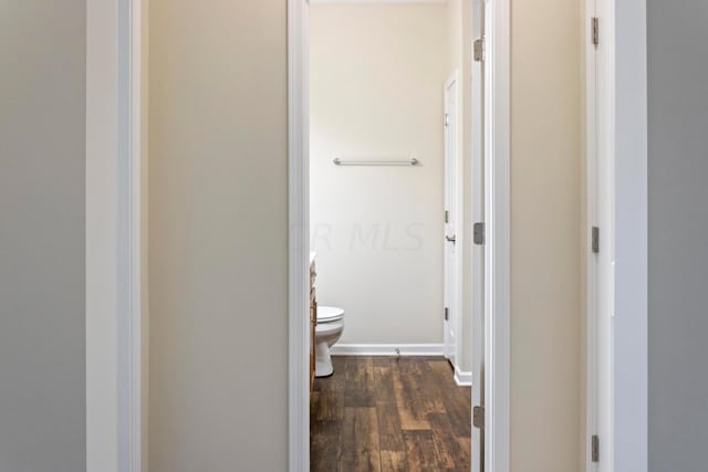 bathroom featuring toilet and wood-type flooring