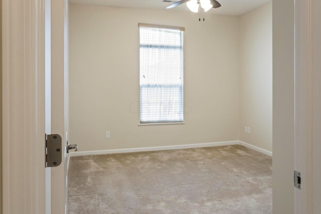 unfurnished room featuring ceiling fan and light carpet