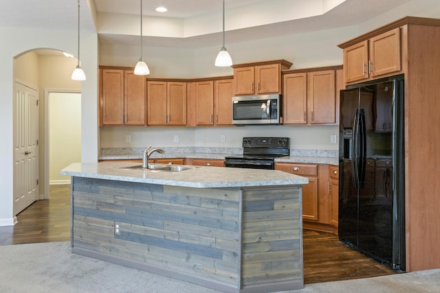 kitchen with black appliances, dark hardwood / wood-style floors, pendant lighting, and sink