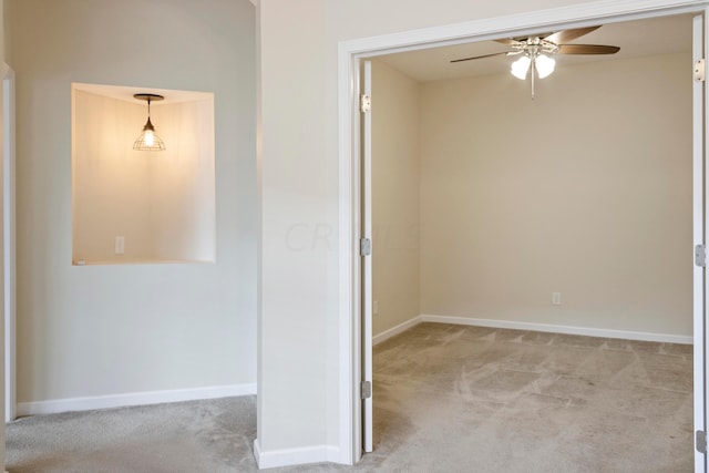 carpeted empty room featuring ceiling fan