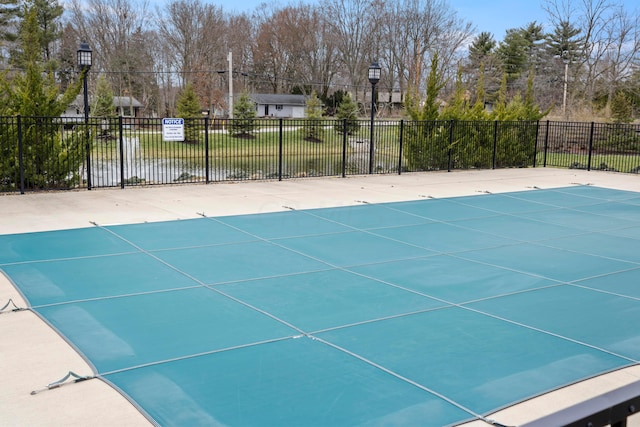 view of swimming pool with a water view