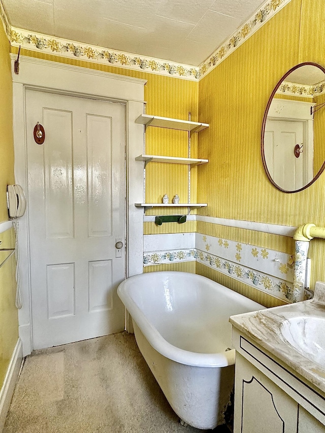 bathroom with a bathing tub and vanity