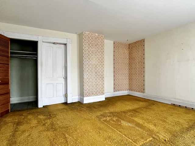 unfurnished bedroom with carpet and a closet