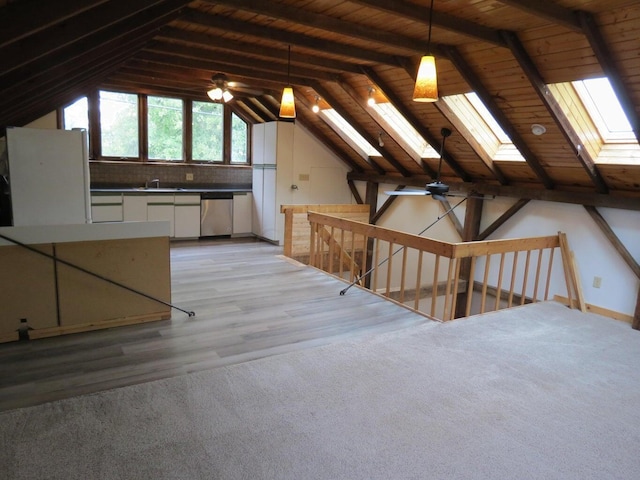 bonus room featuring ceiling fan, sink, light hardwood / wood-style floors, vaulted ceiling with skylight, and wood ceiling