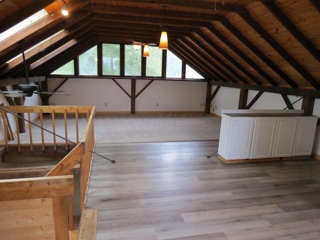 interior space featuring wood ceiling, lofted ceiling with beams, and light hardwood / wood-style floors