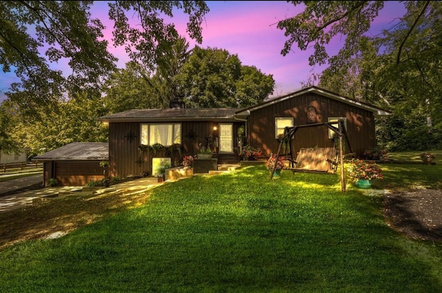 ranch-style house with a lawn