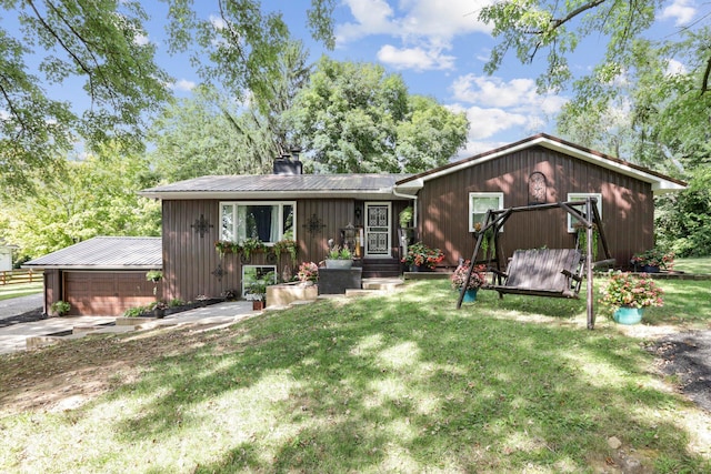 view of front of property with a front lawn and a garage