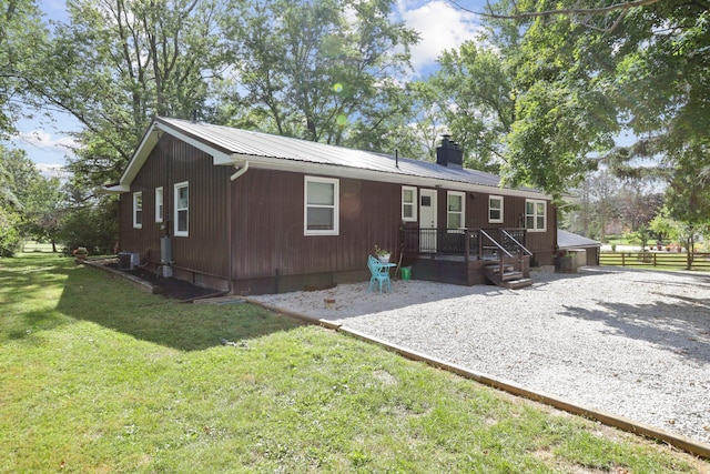 rear view of house featuring a yard, a patio, and central AC unit